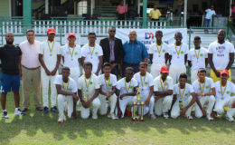 The triumphant Berbice Combined side share a moment with Director of Sport, Christopher Jones, Demerara Mutual Life Assurance Society representative, Clarence Perry and GCB treasurer Anand Kalladeen, after their empathic 10-wicket win over Essequibo. 