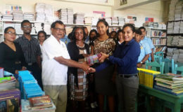 Jenny Chand (at right) making the donation to Charlie Amar in the presence of the school’s headmistress, teachers and students.

