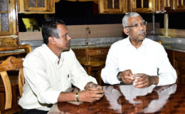 President David Granger (right) sitting with proprietor of Bunny and Sons, a household furniture and fixtures store in Region Five.  (Ministry of the Presidency photo)

