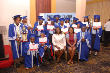 The graduates of the Open Doors Centre, along with Minister within the Ministry of Public Health Karen Cummings (seated, third from right) and Director of Rehabilitation Services Ariane Mangar (seated, second from right).
