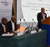 Member of Parliament,   Lord Bruce of Bennachie (at rostrum) chairing the discussion at the Investment Seminar on Guyana, which was facilitated by the Caribbean Council.  President David Granger (seated second from left) led the discussion, which the Minister of Foreign Affairs, Carl Greenidge also participated in. (Ministry of the Presidency photo)