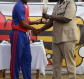  Player of the final Jason Heyliger receives his award from Assistant Commissioner of Police Nigel Hoppie after steering his side home with a defiant 35 not-out while also taking 2-32 when GDF batted.