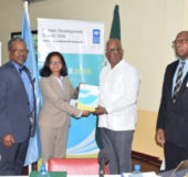 UNDP Deputy Resident Representative, Shabnam Mallick (second from left) hands over the 2016 Human Development Report to Minister of Finance Winston Jordan in the presence of Finance Secretary Dr Hector Butts (right) and Vice Chancellor and Principal of the University of Guyana, Ivelaw Griffith (GINA photo)