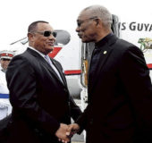 President David Granger being greeted by Bahamian Prime Minister Perry Christie, with the Trans Guyana Beechcraft in the background. (Bahamas Tribune photo)