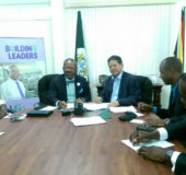 University of Guyana Vice-Chancellor Professor Ivelaw Griffith and Derek Chin, Director of MovieTowne Inc. and the Dachin Group of Companies (at centre), at the signing of the agreements for the implementation of a solar farm and construction of a student housing complex at the Turkeyen Campus. Also present from left are University Registrar Dr. Nigel Gravesande, Hadyn Gadsby, Eusi Anderson and Dr. Paloma Mohamed (standing).
