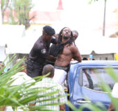 City constables trying to control the shot robbery suspect as he made attempts to escape yesterday in the City Hall compound. (Photo by Keno George)
