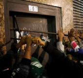 Members of Brazil's Movimento dos Sem-Teto (Roofless Movement) try open the front door of a vacant building during an occupation of an empty building in the early hours of a general strike, in the center of Sao Paulo. REUTERS/Nacho Doce 