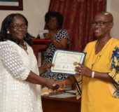Member of Parliament, Jennifer Wade (left) presenting  Mabelene McDonald with her certificate of participation (Ministry of the Presidency photo)
