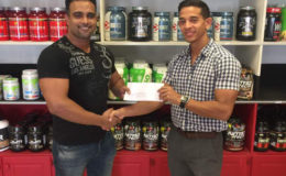 Vice President of the GBBFFI, Seon Satrohan (left) receiving the sponsorship cheque from Fitness Express’ CEO, Jamie McDonald recently at the company’s store at 47 John and Sheriff Streets.