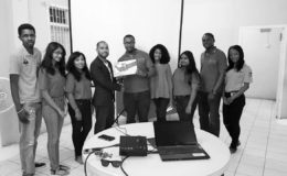 The Board of Directors of the Rotaract Club of Georgetown Central receiving the donation of a projector from the Chairman of Global REACH Guyana, Bruce Camacho. In photo from left to right are Kevin Thomas (Club Service Director), Mariesa Jagnanan (Treasurer/Finance Director), Cherie Rampertab (Vice-President), Bruce Camacho (Founder and Chairman of Global REACH Guyana), Cecil Maxwell (President), Laurel Dundas (Secretary), Nandani Deokaran (International Service Director), Asa Stuart-Shepherd (Professional Development Director) and Sheena McLean (Community Service Director).
