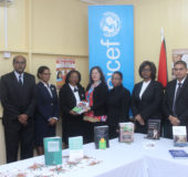 UNICEF Representative for Guyana and Suriname Sylvie Fouet (centre) hands over the legal texts to Acting Chancellor Justice Yonette Cummings-Edwards (third, left). Looking on from left are: Justice Rishi Persaud, Justice Sandra Kurtzious, Acting Chief Justice Roxane George, Justice Dawn Gregory and Justice Nareshwar Harnanan. 