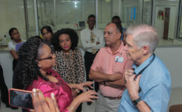  Minister of Public Health Volda Lawrence interacts with Dr. J Wayne Warnica as other GPH officials look on. 
