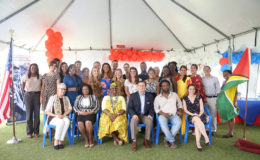 US Embassy Deputy Chief of Mission (DCM) Terry Steers-Gonzalez (third, right) and Minister of Public Health Volda Lawrence (second, left) flanked by government and other officials and the new volunteers