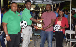 Petra Organization member Mark Alleyne (2nd from left) presenting the contribution to WDFA Secretary Adrian Giddings while Petra Organization Co-Director Troy Mendonca and Women’s Football Association President Charmaine Wade look on.