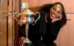 Serena Williams sits next to the trophy after winning the Australian Open (Fiona Hamilton/ Courtesy of Tennis Australia/Handout via REUTERS)
