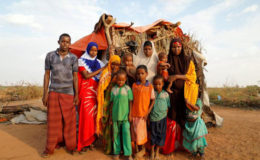 Zeinab, 14, (2nd L) poses for photograph with her family beside their shelter at a camp for internally displaced people from drought hit areas in Dollow, Somalia April 3, 2017. (Reuters/Zohra Bensemra)