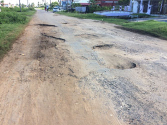 A section of the road covered with craters
