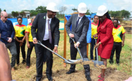 FIFA President Gianni Infantino (centre) GFF Chief Wayne Forde and Minister within the Ministry of Education Nicolette Henry officially ‘turning the sod’ on the Providence Community ground, the site for country’s first FIFA ‘Forward Programme’ facility. (Orlando Charles photo)