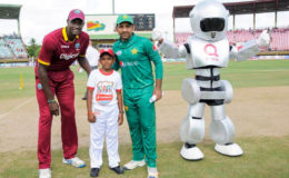 CAPTAINS ALIKE! 11-year-old Azam Mohammed, captain of Enterprise Primary School shares a photo opportunity with captains Jason Holder and Sarfraz Ahmed of the West Indies and Pakistan respectively at the coin toss prior to Sunday’s second ODI  at the Providence National Stadium.
