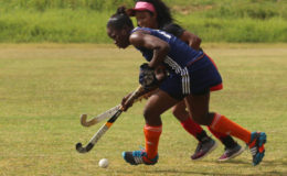 Shebiki Baptiste (on the inside) of Pizza Hut GCC on the attack while being challenged by an Old Fort player in the second Woodpecker Products women’s first-division league at the St. Stanislaus ground, Carifesta Avenue last weekend.