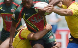 Patrick King tries to evade the Spain defense during their Cathay Pacific /HSBC Hong Kong Sevens qualifier matchup yesterday. Spain defeated Guyana 47-5. The speedy winger, King, was Guyana’s lone scorer.