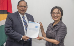Prime Minister Moses Nagamootoo (left) receiving the report from UN Resident Coordinator Mikiko Tanaka (Office of the Prime Minister photo)