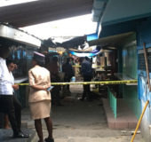 The police investigators examining the crime scene yesterday afternoon at the Bourda Market. 