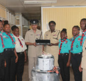 Woman Assistant Commissioner of Police, Maxine Graham (fifth from right) handed over the instruments ‘E’ Division Commander Senior Superintendent Fizal Karimbaksh in the presence of the force Director of Music, Charmaine Stuart and some scouts.