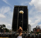 A demonstrator holds up a flower in front of riot policemen during a women’s march to protest against President Nicolas Maduro’s government in Caracas, Venezuela, May 6, 2017. (Reuters/Carlos Garcia Rawlins)