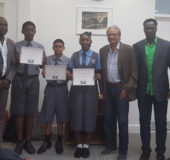 Minister of Education Dr Rupert Roopnaraine (third, right) with some officials of the Guyana Chess Federation (GCF) and three students of St Stanislaus College in his Brickdam office on Wednesday. The students are displaying certificates of completion of a chess training programme which was organized by the GCF. From left are: National Chess Champion Wendell Meusa, GCF President James Bond, Jaden Taylor, Ghansham Allijohn, Jessica Callender, Minister Roopnaraine, Vice President of the GCF Frankie Farley and honorary member of the GCF Errol Tiwari.