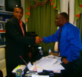Councillor Jameel Rasul (left) being congratulated by Town Clerk Royston King in his office after being sworn in.