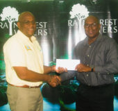  President of the Guyana Boxing Association Steve Ninvalle receives the sponsorship cheque from Clive Pellew, Brand Manager (Water)