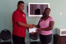 A representative of Mohan’s Construction Inc. presents their sponsorship pact to one of the organisers of the May 21 event.