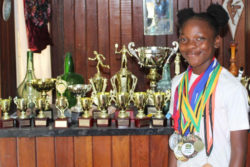 Abosaide Cadogan as she displays some of her accomplishments. 