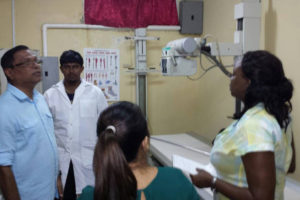 Dr Vishwa Mahadeo (left) speaking with staff of the Oscar Joseph District Hospital