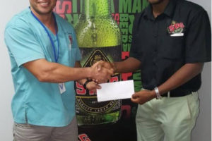 Public Relations Officer (PRO) of the federation and national lifter, Osmond ‘Billy’ Mack, symbolically receives the sponsorship package from Ansa McAL’s Marketing Assistant, Keon Persaud. 