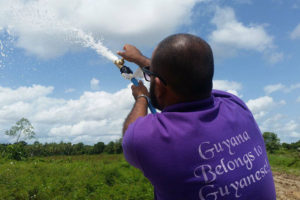 GWI Division Manager (Berbice), Jim Ramjug opening the pipe to the distribution network for the very first time.