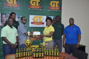 Shanay Gomes (3rd from right), Managing Director of Xtreme Clean collecting the sponsorship cheque from Banks DIH Limited GT Beer Brand Manager Jeff Clements (3rd from left) in the presence of other members of both companies 