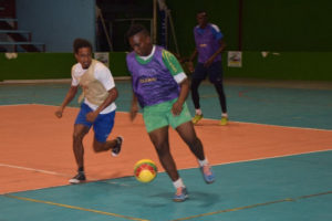 Ryan Hackett (ight) of Tucville on the attack while being pursued by Sophia’s Dwayne Lowe during their group stage fixture at the National Gymnasium in the Xtreme Clean/GT Beer Futsal Championship