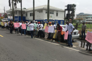 The protestors outside of the Guyana Geology and Mines Commission headquarters on Brickdam yesterday. 