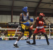 Barbados’ Tevin Brewster (left) mixing it up against Shemar Morrison Friday night at the National Gymnasium. 