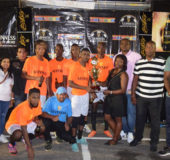 Captain of the newly crowned Guinness ‘Greatest of the Streets’ Linden edition champion Dave and Celina All-Stars, Kennard Simon, (centre) collecting the championship trophy from Guinness Linden Brand Manager Shondel Easton in the presence of teammates and members of Banks DIH, inclusive of Guinness Brand Manager Lee Baptiste (right) and Outdoor Event Manager Mortimer Stewart (2nd right)