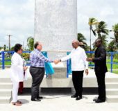 Norman Sabga (second from left) shaking hands with President David Granger at the arch.