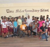 Teachers and students of Three Miles Secondary School posing with some athletes and members of the bodybuilding federation.
