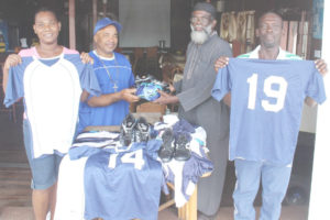 Overseas Disturbance Sports Club, member Orin Humphrey as he hands over a number of football gears to secretary of the Sanata Point Cooperate Society Eric Francois, Friday.
