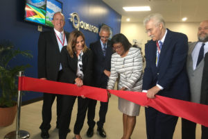 Minister of Public Telecommunications, Catherine Hughes (third from right) cutting the ribbon to the second building at the Qualfon Providence Campus yesterday, along with President of Qualfon Guyana, Christina Morris (second from left) and Vice President, Operations of  Qualfon Guyana, Richard Brinson (second from right).
