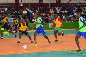 Gregory Richardson (centre) of Sparta Boss initiating an attack against  Tucville at the National Gymnasium in the Xtreme Cleaners/GT Beer Futsal Championship