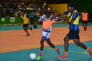 Lennox Cort (left) of Albouystown battling with Gerald Gittens of North Ruimveldt for possession of the ball at the National Gymnasium (Orlando Charles photo)