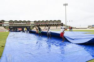 (Caption) Ground-staff at the Darren Sammy Cricket Ground mount mop up operations before heavy rains returned to force the abandonment of the third ODI. (Photo courtesy CWI Media) 
