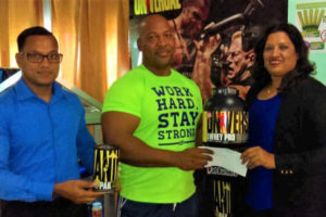 Chief Executive Officer of IPA, Reginald Persaud (left), ‘Big’ John Edwards (centre) and Manager of Non-Pharmaceutical Shamieza Yadram pose with the sponsorship pact that Edwards received recently at the company’s Camp Street office.